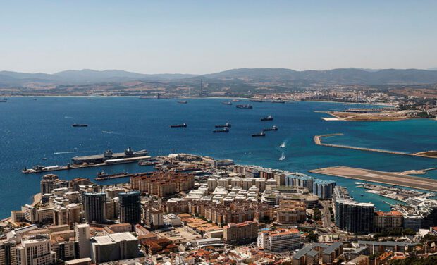 An aerial view of the strait of Gibraltar with a number of ships in the water
