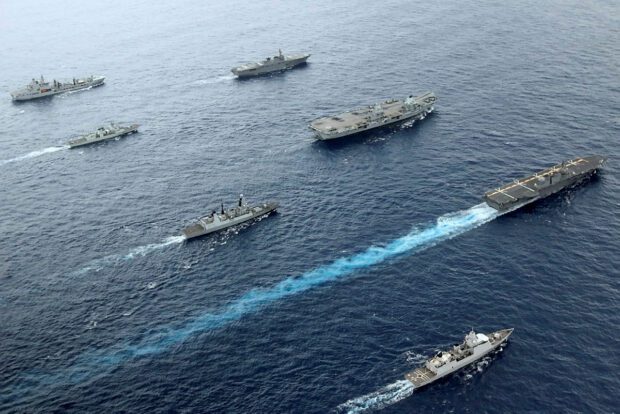 The carrier strike group sailing on the ocean