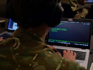 Individual at computer screen during Defence Cyber Marvel 2