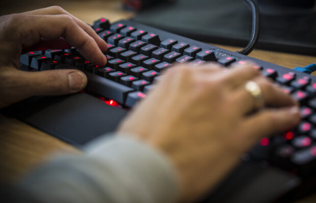 red keyboard and typist